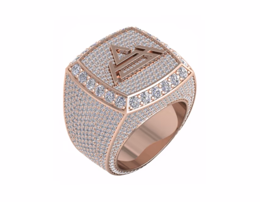 Iced rose-gold championship signet with a raised triangle peak motif.