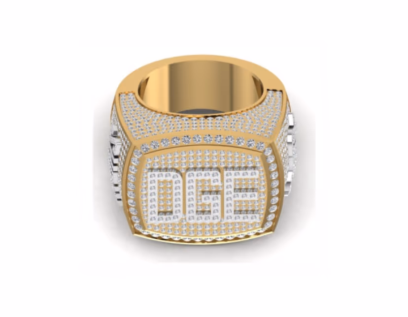 Bold iced DGE block-letter signet on a fully pavé championship setting.