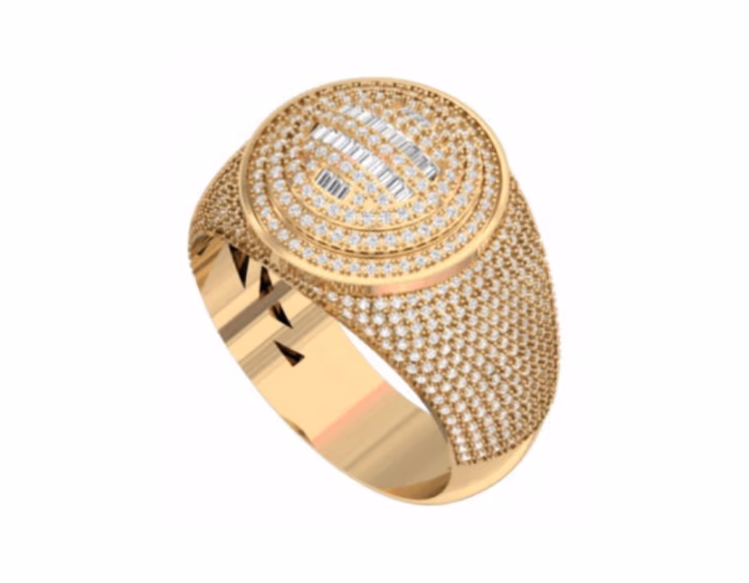 Oval iced signet with a raised baguette monogram on a dense pavé bed.