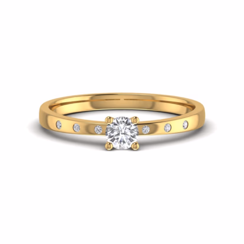 Tiny single-diamond accent ring on polished gold.