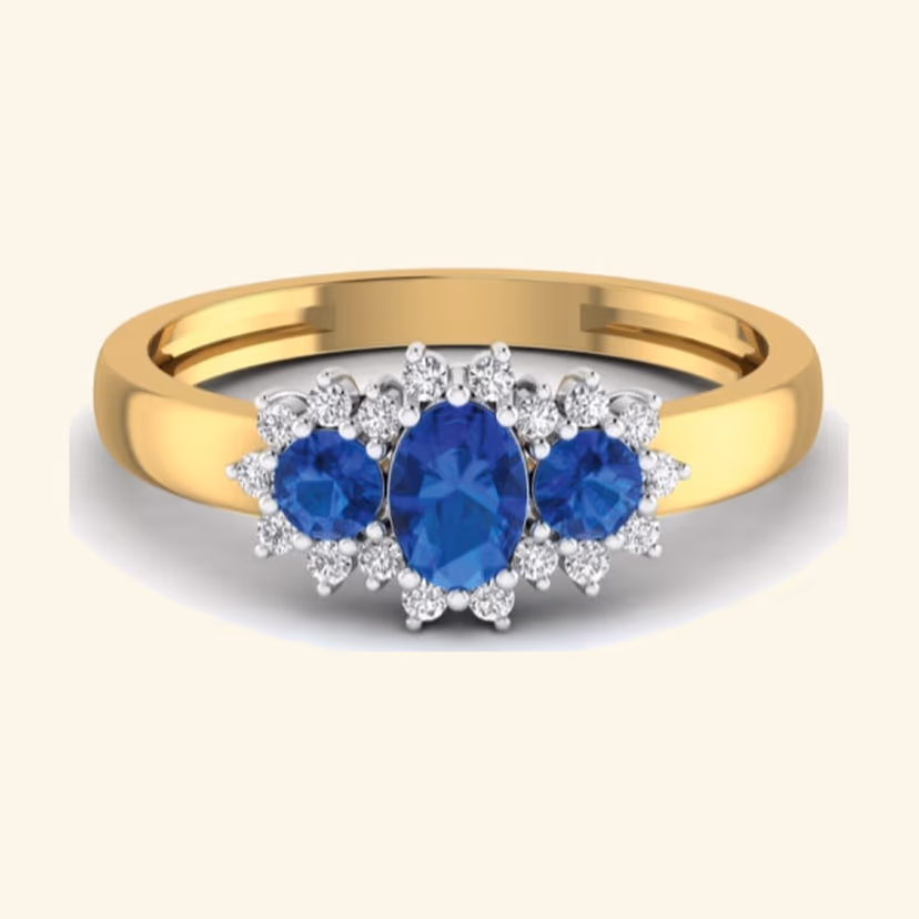 Three-stone oval sapphire trilogy ring with pavé cluster halos.