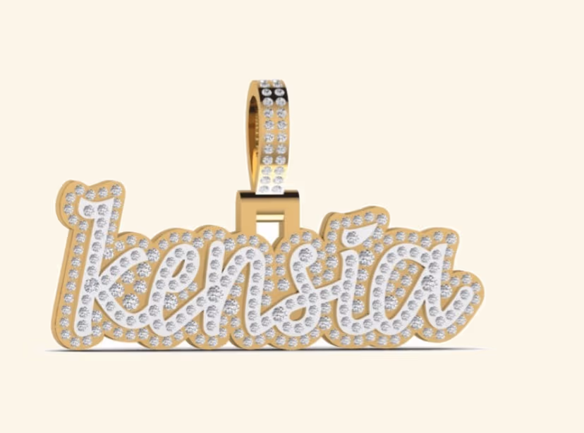 Cursive Kensia pavé nameplate pendant with milgrain border and double-pavé bail.