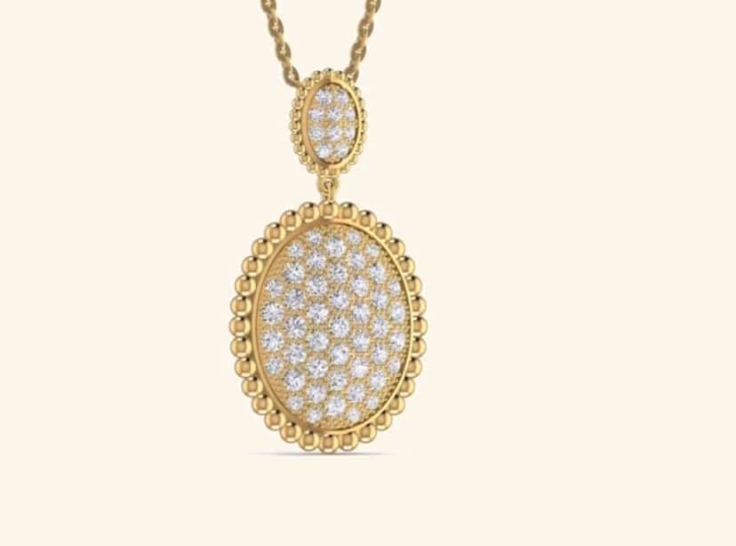 Oval pavé locket pendant with beaded gold border and matching small oval bail.