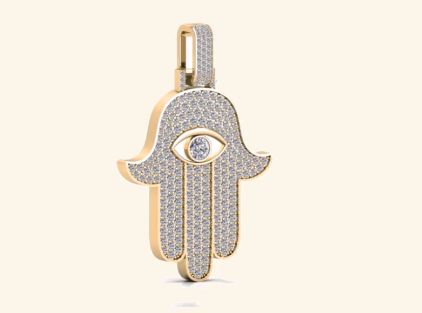 Pavé hamsa hand pendant with central evil-eye stone and matching pavé bail.