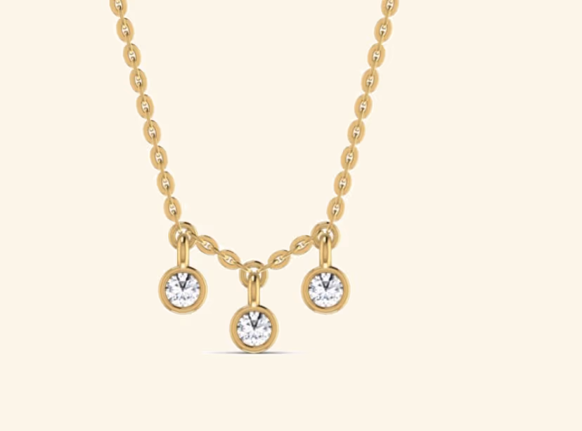 Triple-bezel round drop pendant suspended from a cable chain.