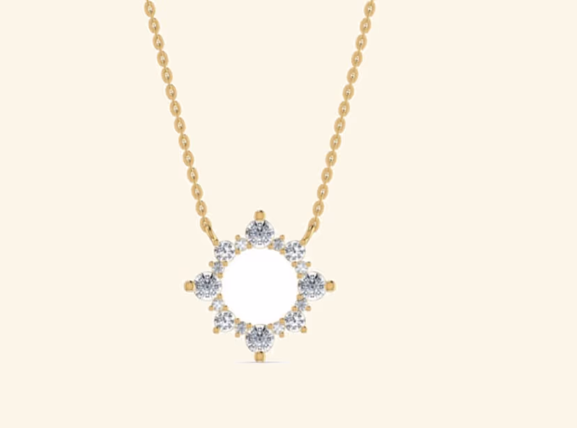 Open eight-point starburst frame of bezel-set rounds with chain through the centre.