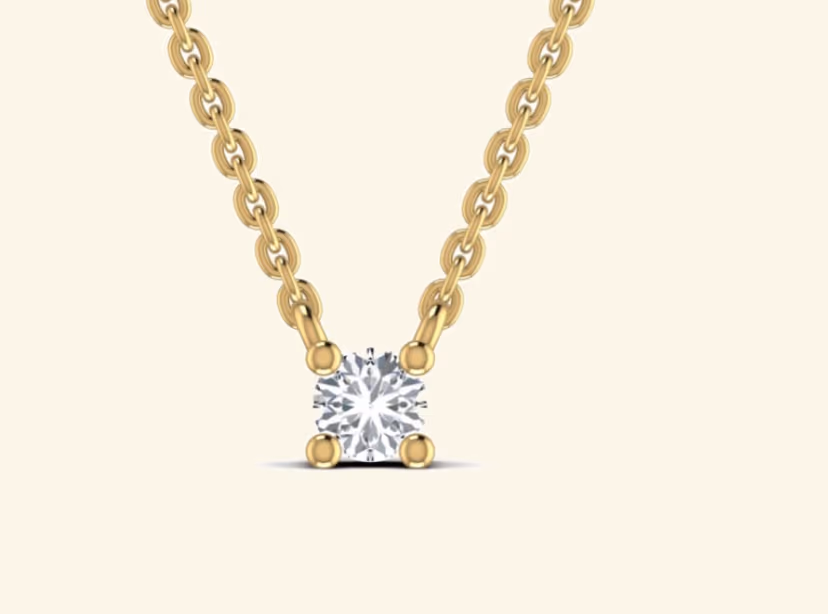 Single round prong-set solitaire on a slim cable bar pendant.