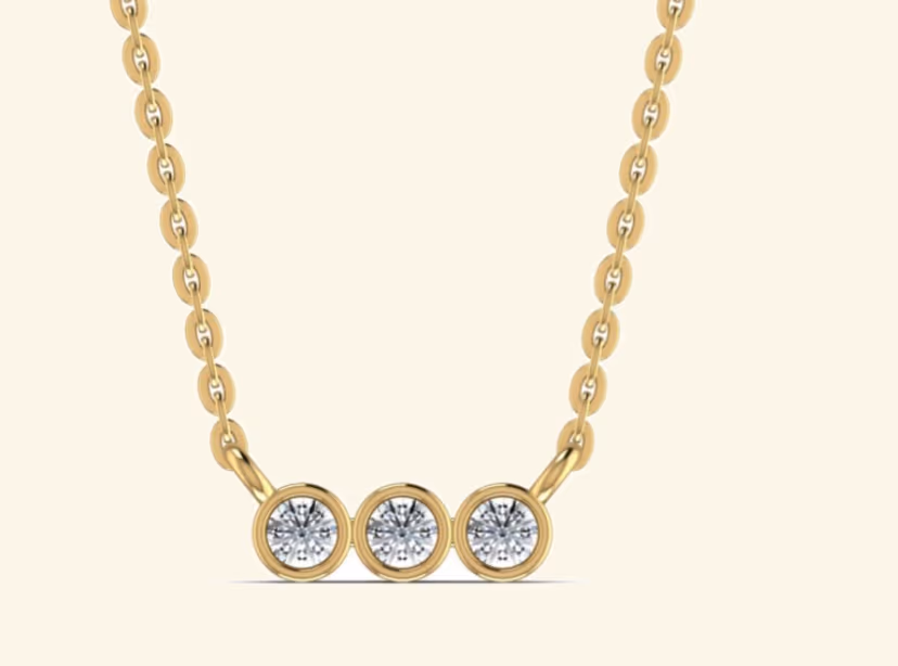 Three bezel-set rounds in a horizontal mini-bar pendant on cable chain.