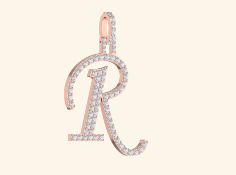 Cursive script R pavé pendant in rose gold with pavé bail loop.