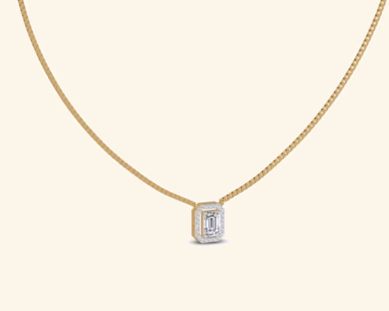 Emerald-cut diamond pendant with pavé halo on a slim box chain.