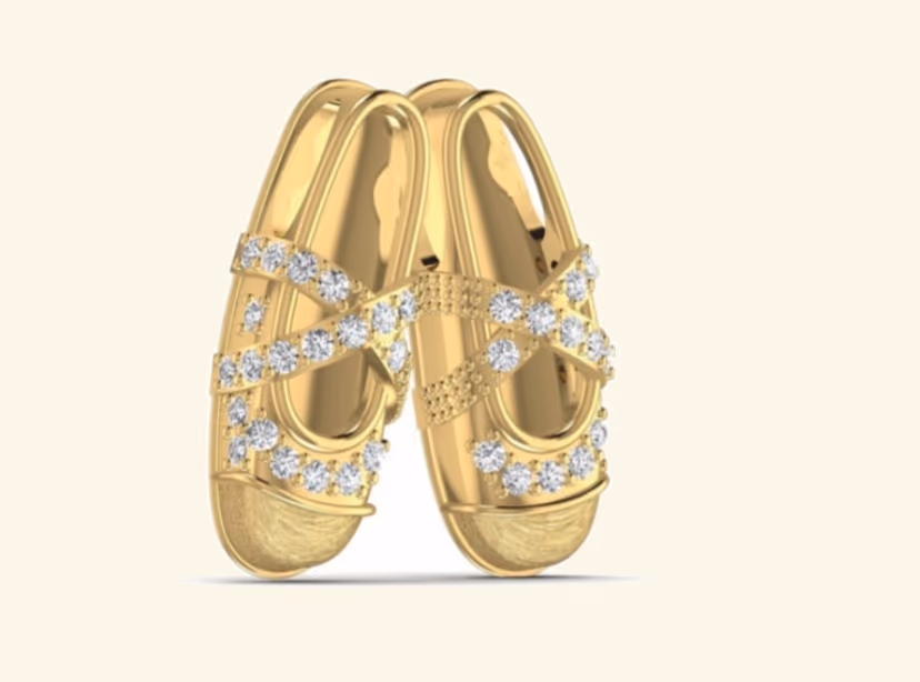 Pair of baby slipper pendants with criss-cross pavé strap detail.